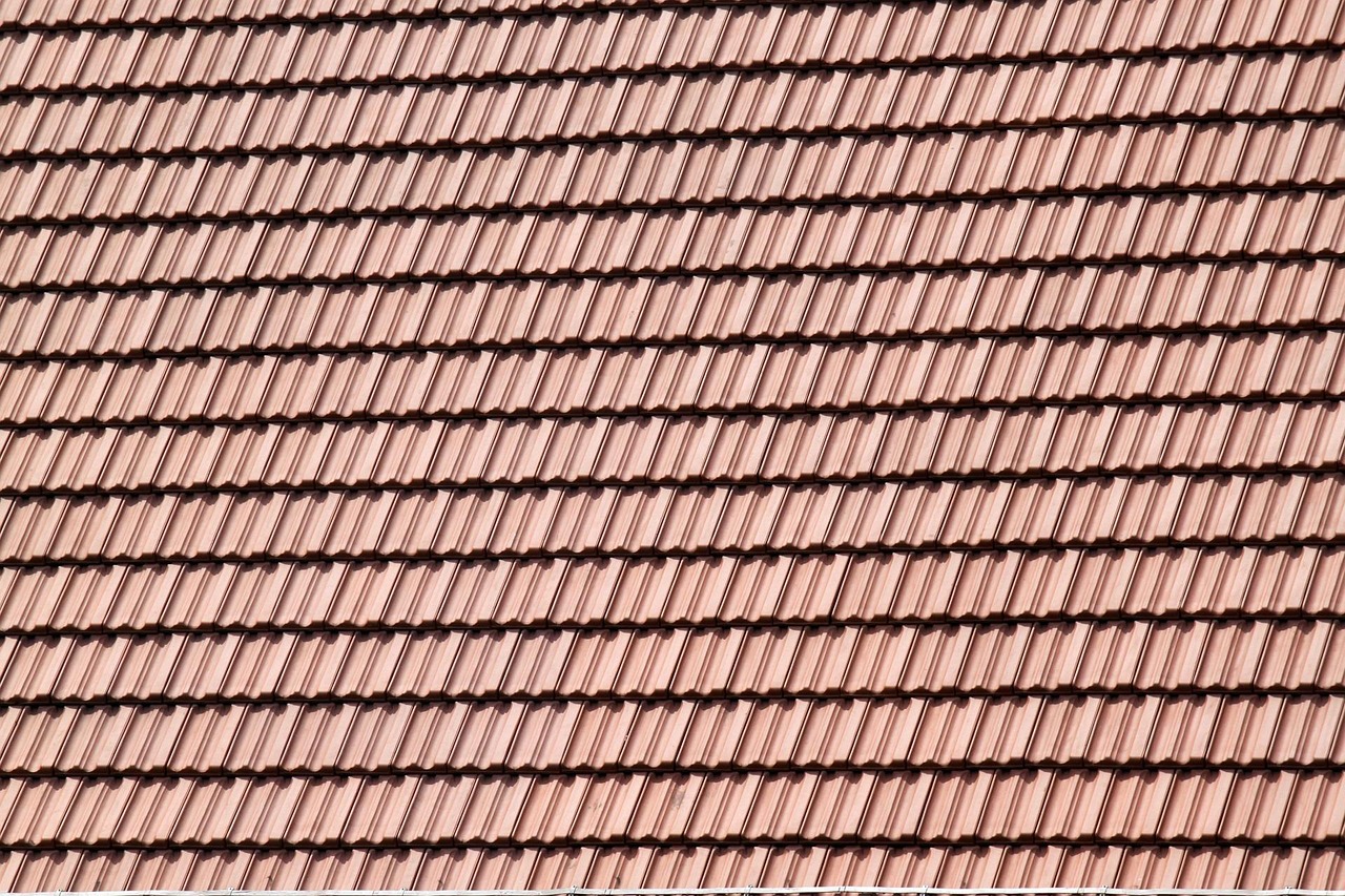 roofer inspecting hail damage on roof