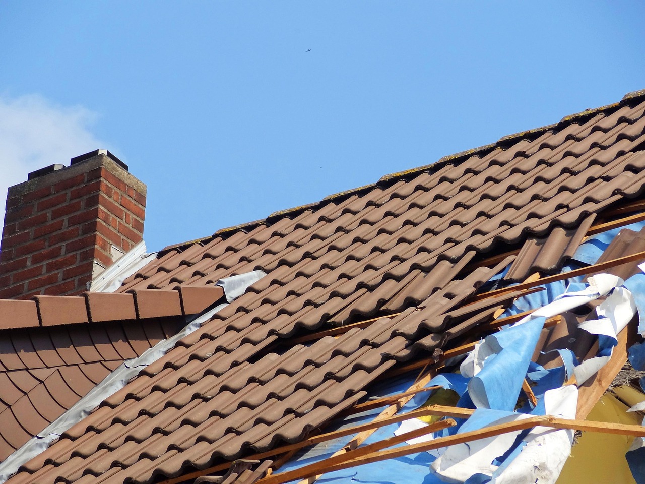 roofer repairing storm damaged roof