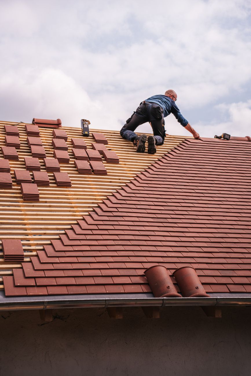 roofer inspecting Winnipeg hail damaged roof